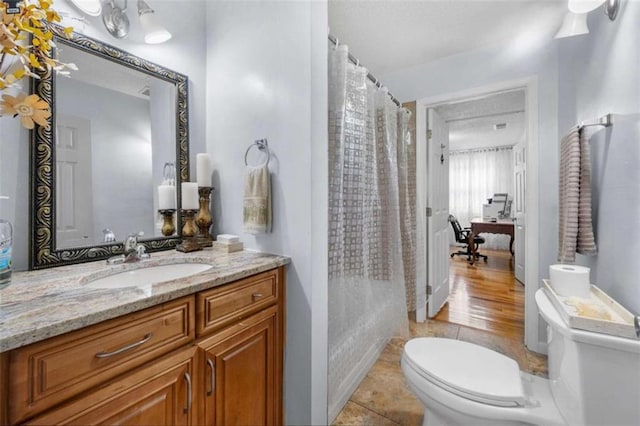 2021 Sherwood Dr SE, Marietta, GA 30062 - full bathroom with toilet, vanity, a shower with shower curtain, and tile patterned flooring