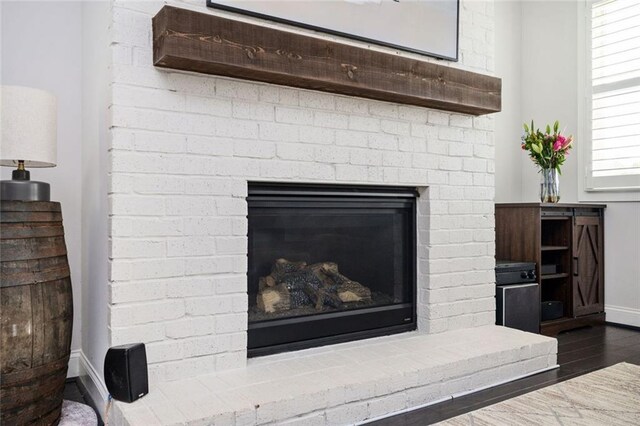 2026 Forte Ln, Alpharetta, GA 30009 - detailed view of baseboards, a brick fireplace, and wood finished floors