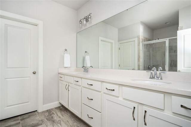 2026 Forte Ln, Alpharetta, GA 30009 - bathroom with double vanity, a shower stall, marble finish flooring, and baseboards