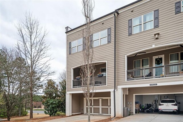 2026 Forte Ln, Alpharetta, GA 30009 - view of building exterior with an attached garage, driveway, and central AC