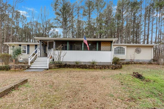 view of front of property with crawl space and a sunroom