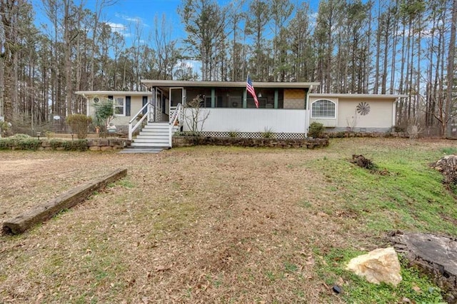 ranch-style home with a sunroom and a front lawn