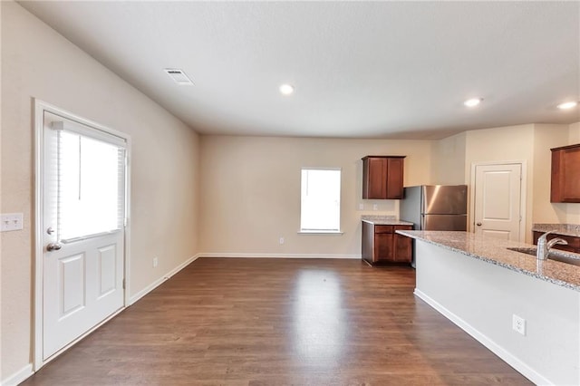513 Moline Way, Locust Grove, GA 30248 - kitchen with plenty of natural light, freestanding refrigerator, a sink, light stone counters, and recessed lighting