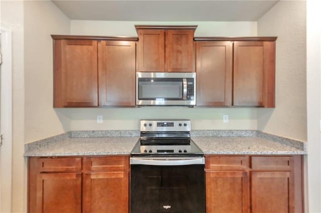 513 Moline Way, Locust Grove, GA 30248 - kitchen featuring appliances with stainless steel finishes, light countertops, and brown cabinetry
