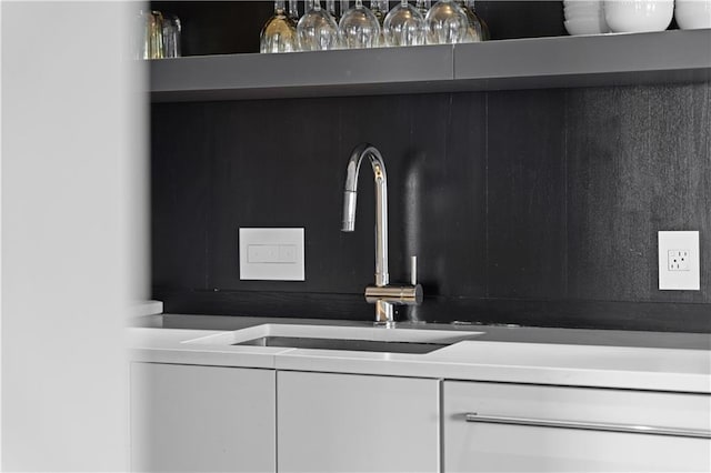 room details featuring sink and white cabinets