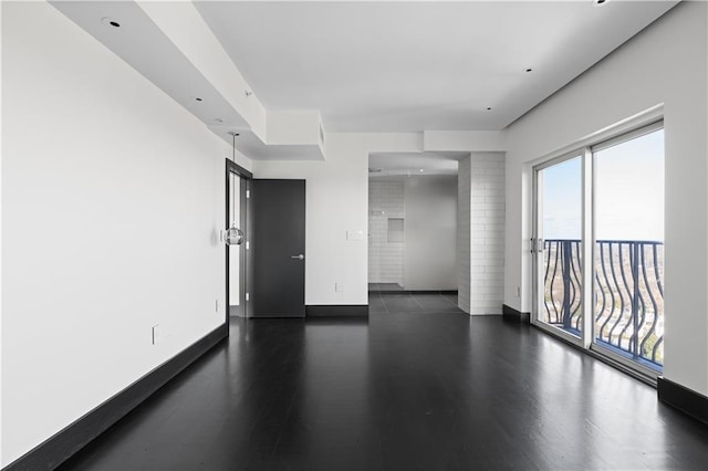 unfurnished room featuring dark wood-type flooring