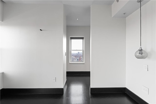 spare room with dark wood-type flooring