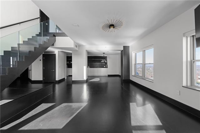 unfurnished living room with dark wood-type flooring