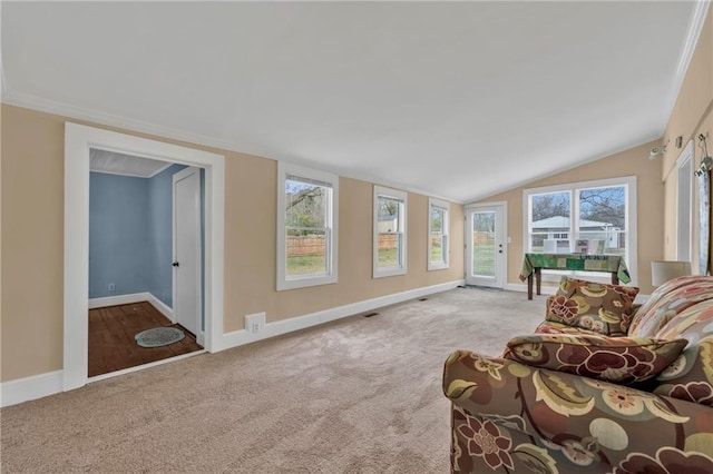 interior space with ornamental molding, carpet, vaulted ceiling, and baseboards