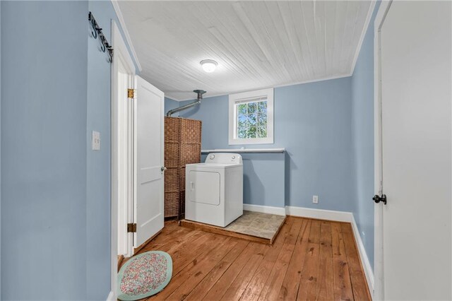 washroom with washer / dryer, laundry area, baseboards, hardwood / wood-style flooring, and ornamental molding