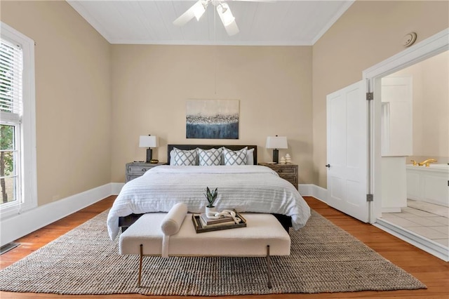 bedroom featuring ceiling fan, baseboards, and wood finished floors