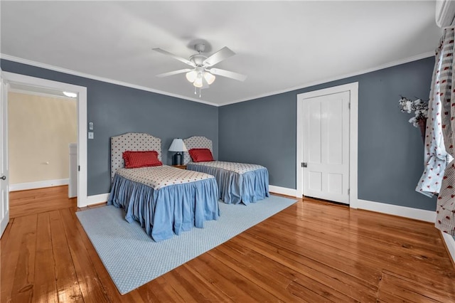 bedroom with crown molding, baseboards, ceiling fan, and hardwood / wood-style floors