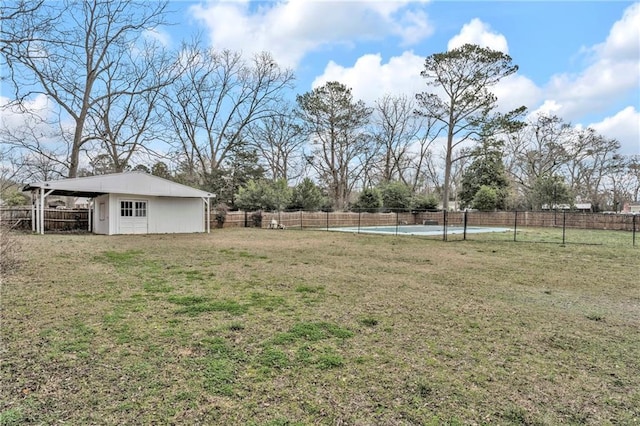 view of yard with an outbuilding and fence