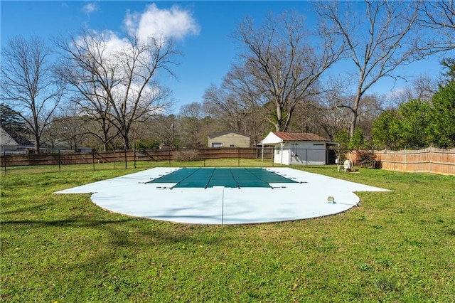 view of pool with a fenced backyard and a yard