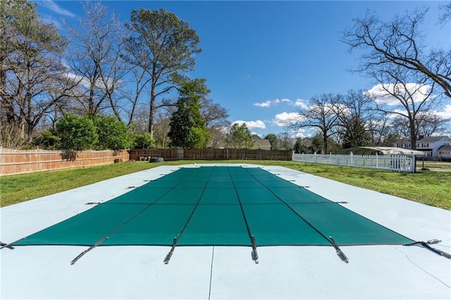 view of pool featuring a fenced backyard and a yard