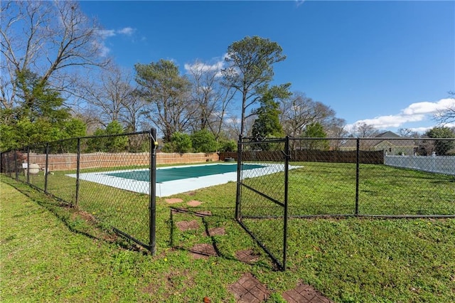 view of swimming pool with community basketball court, fence, and a yard