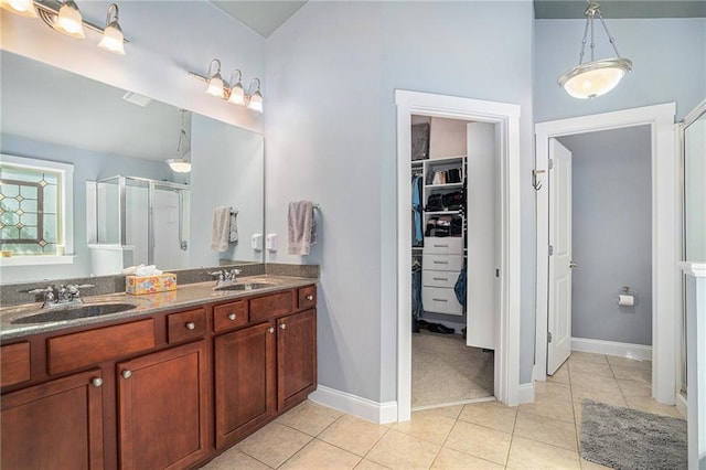 bathroom with lofted ceiling, tile patterned floors, vanity, and a shower with shower door