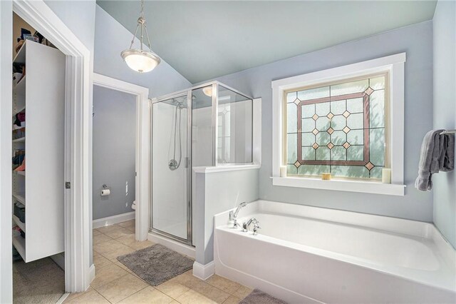 bathroom with tile patterned flooring, separate shower and tub, and toilet