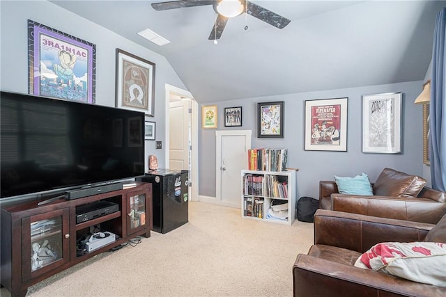 living room with ceiling fan, vaulted ceiling, and light colored carpet