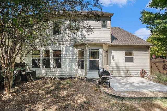 back of property with a patio