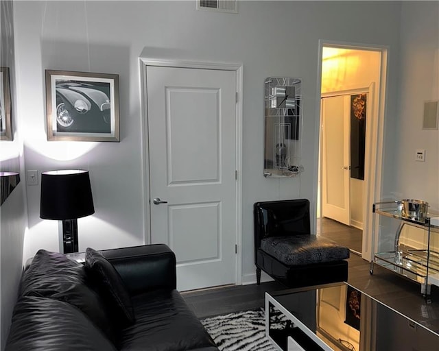 living room featuring visible vents and dark wood-style flooring