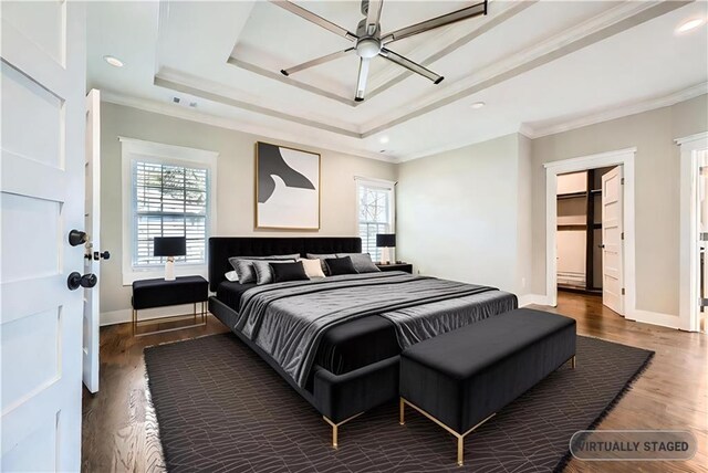 bedroom featuring multiple windows, a spacious closet, ceiling fan, and ornamental molding