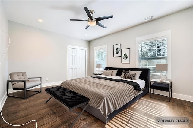 bedroom with ceiling fan, a closet, and dark hardwood / wood-style floors