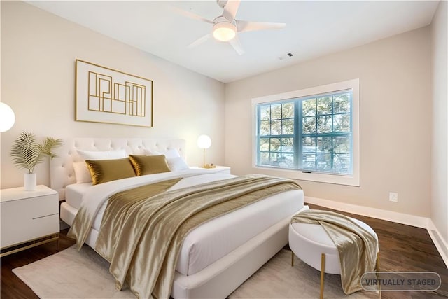 bedroom with ceiling fan and hardwood / wood-style flooring