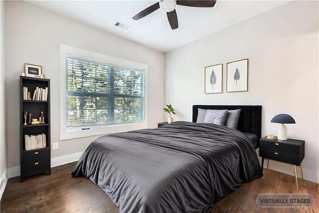 bedroom with dark hardwood / wood-style flooring and ceiling fan