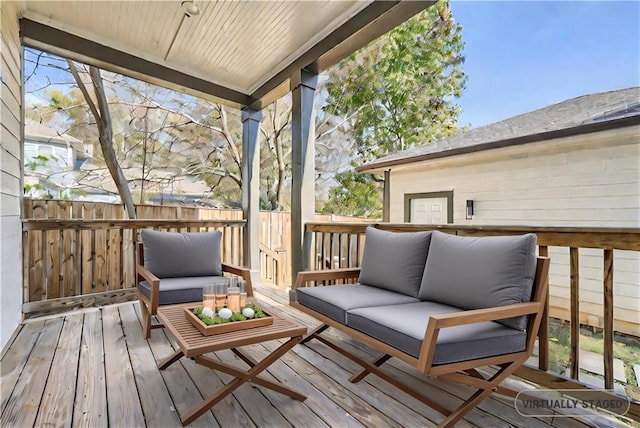 wooden terrace featuring an outdoor living space