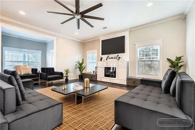 living room featuring a healthy amount of sunlight and crown molding