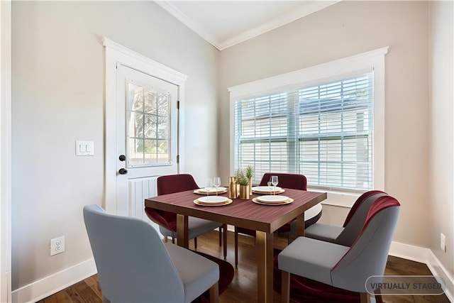 dining area featuring dark hardwood / wood-style floors and ornamental molding