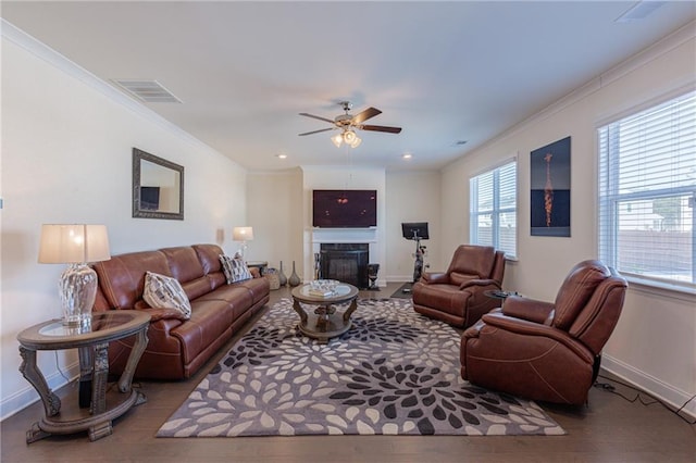 living room featuring ceiling fan and crown molding