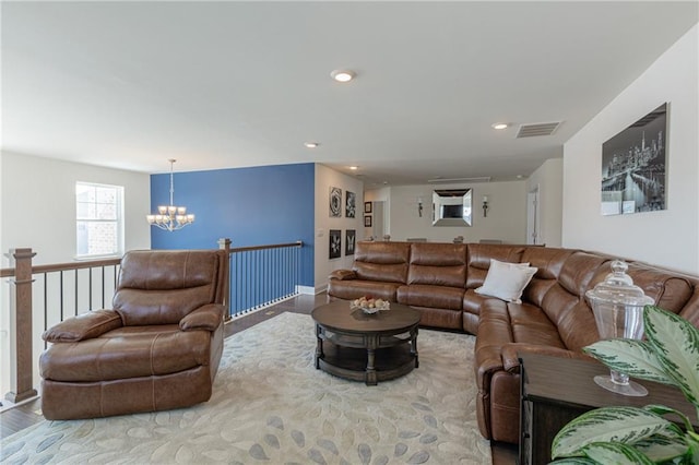 living room featuring an inviting chandelier and wood-type flooring