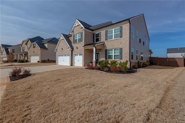 view of front of house with solar panels, a front yard, and a garage