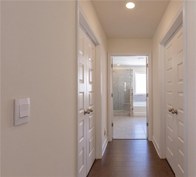 hall with dark wood-type flooring