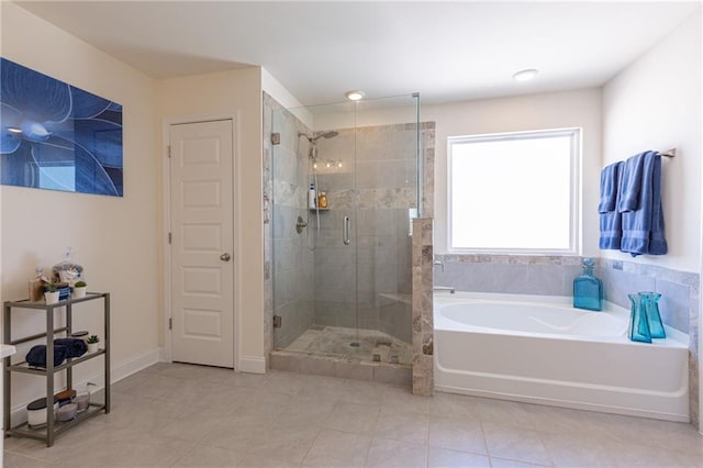 bathroom with independent shower and bath and tile patterned flooring