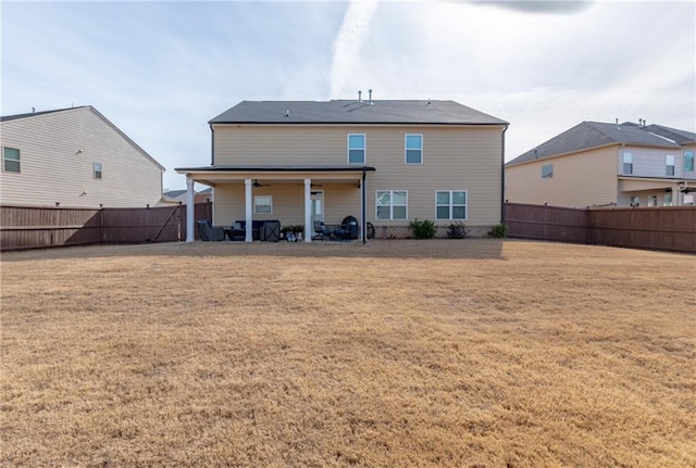 rear view of house featuring a yard