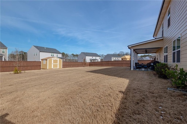 view of yard featuring a storage unit and ceiling fan