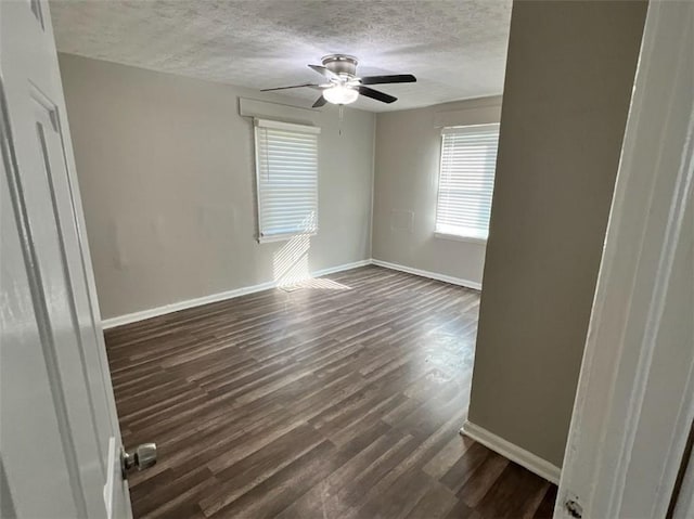 spare room with ceiling fan, dark hardwood / wood-style floors, and a textured ceiling