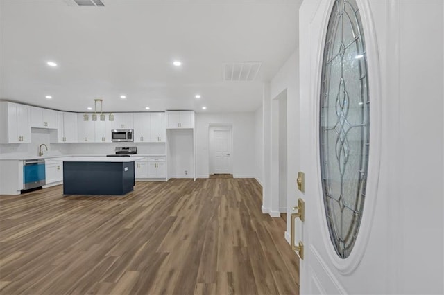 kitchen with stainless steel appliances, visible vents, light countertops, and white cabinetry