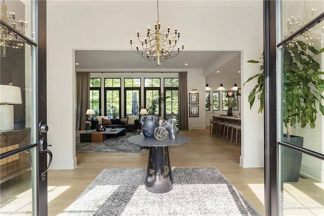 320 Shady Grove Ln, Alpharetta, GA 30009 - foyer entrance with a chandelier, wood finished floors, and a towering ceiling