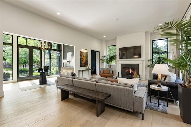 320 Shady Grove Ln, Alpharetta, GA 30009 - living room with a warm lit fireplace, wood finished floors, and recessed lighting