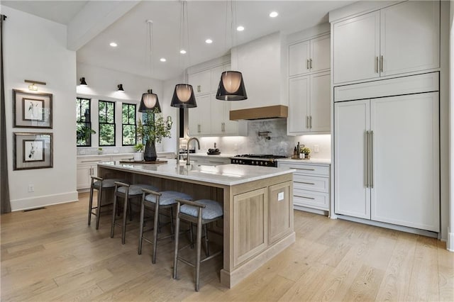 320 Shady Grove Ln, Alpharetta, GA 30009 - kitchen with paneled fridge, a sink, light countertops, light wood finished floors, and decorative backsplash