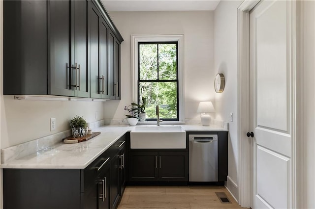 320 Shady Grove Ln, Alpharetta, GA 30009 - kitchen with stainless steel dishwasher, a sink, light wood-style floors, and light stone countertops