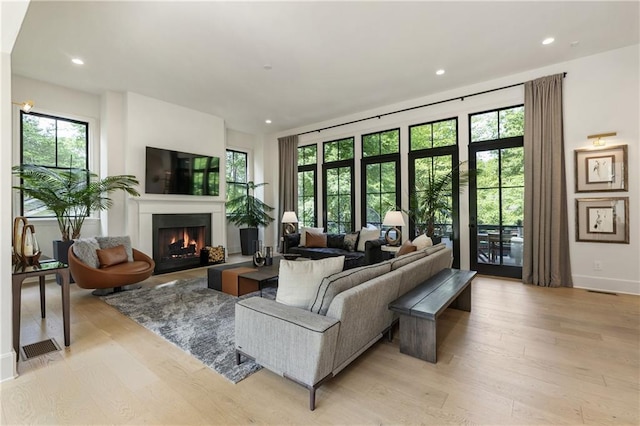320 Shady Grove Ln, Alpharetta, GA 30009 - living area featuring a lit fireplace, light wood-style floors, recessed lighting, and baseboards