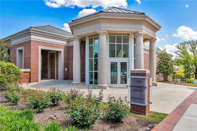 320 Shady Grove Ln, Alpharetta, GA 30009 - doorway to property featuring a standing seam roof, metal roof, fence, and brick siding