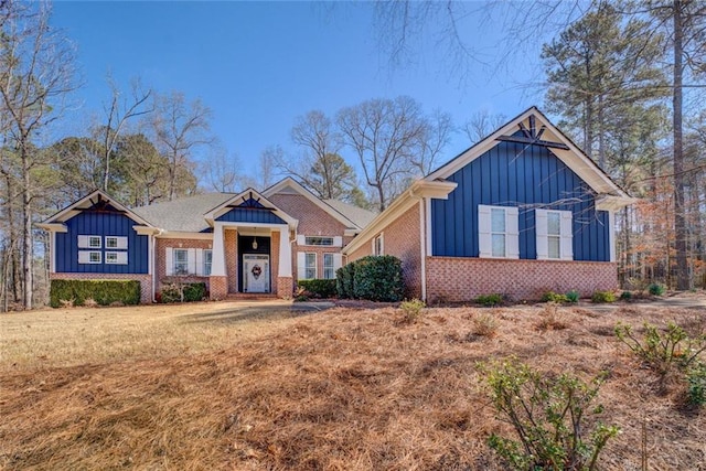 view of front of house with board and batten siding and brick siding
