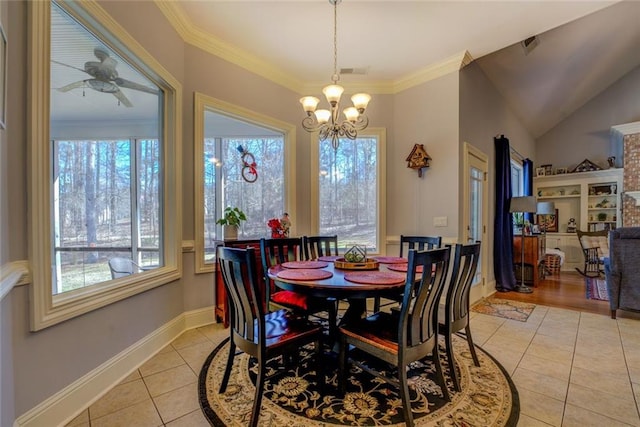 dining room with light tile patterned flooring, a chandelier, crown molding, baseboards, and ceiling fan
