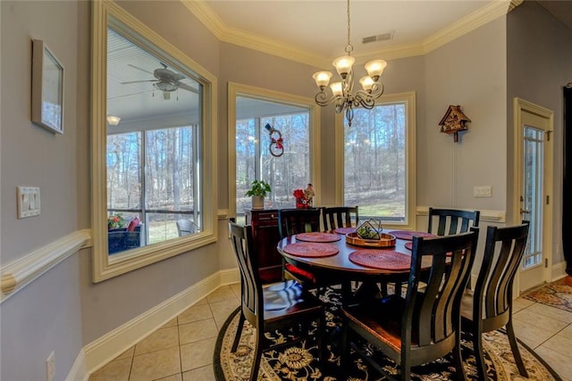 dining room featuring light tile patterned floors, crown molding, ceiling fan, a chandelier, and baseboards